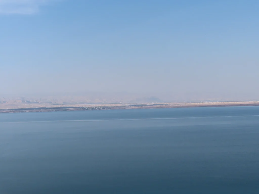 Pale sky above the Dead Sea and distant shore, seen from Jordan
